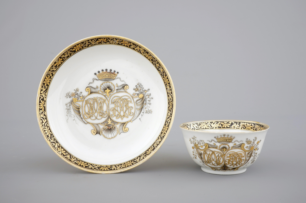 A Chinese grisaille and gilt export porcelain armorial cup and saucer, 18th C