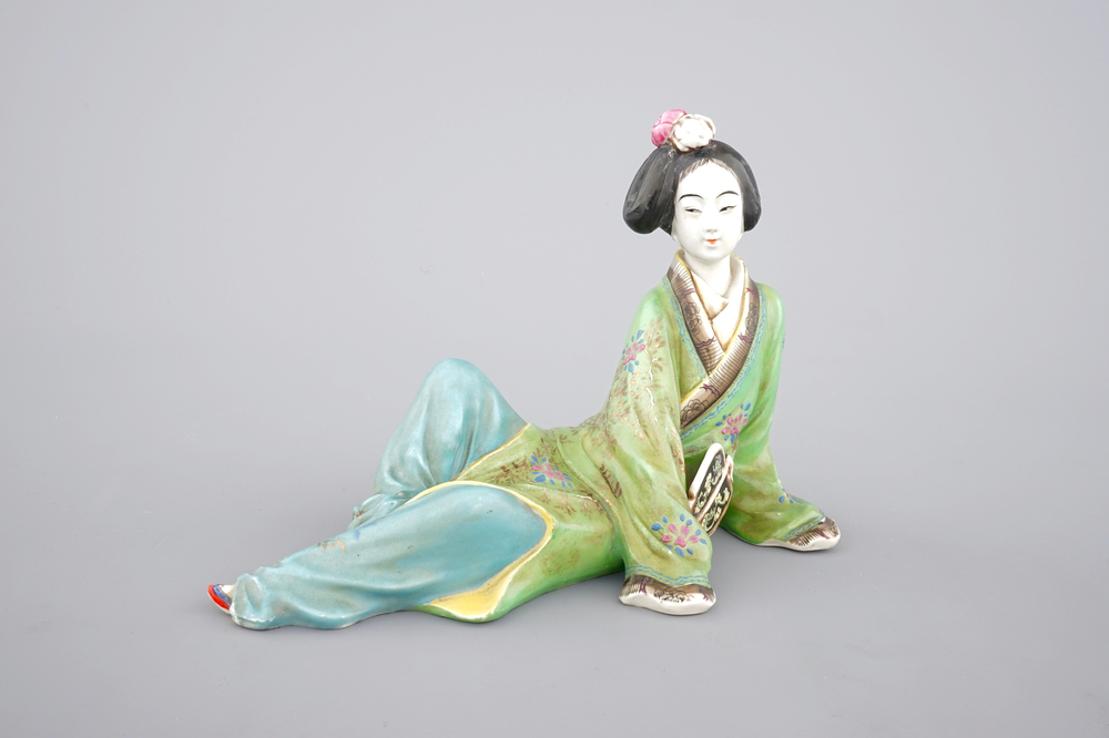 A Chinese famille rose porcelain figure of a reclining lady, 20th C