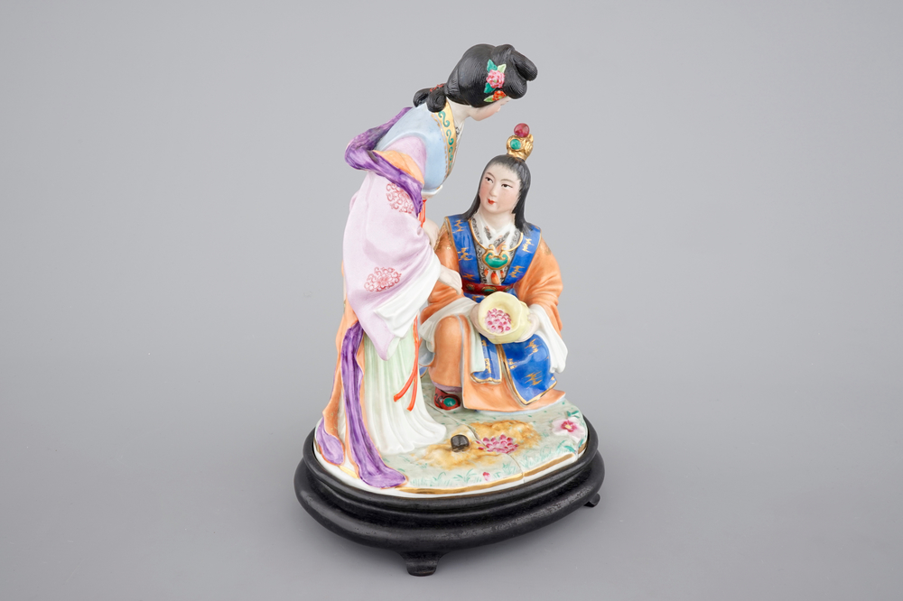 A fine Chinese porcelain figural group on a wooden stand, 20th C