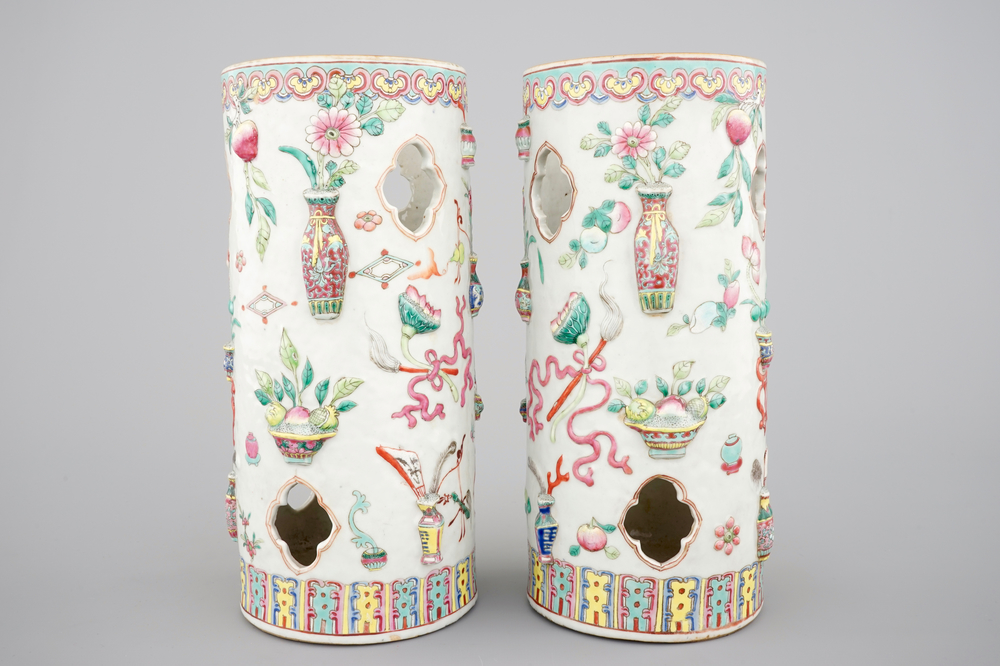 A pair of Chinese famille rose porcelain relief-moulded hat stands, 19th C.