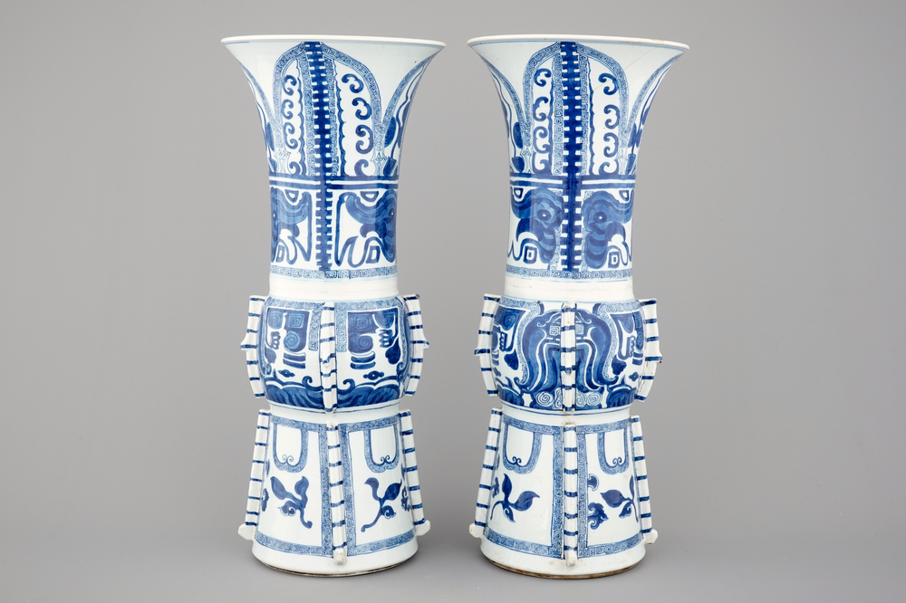An unusual pair of tall Chinese blue and white porcelain gu-shaped vases, Kangxi, ca. 1700
