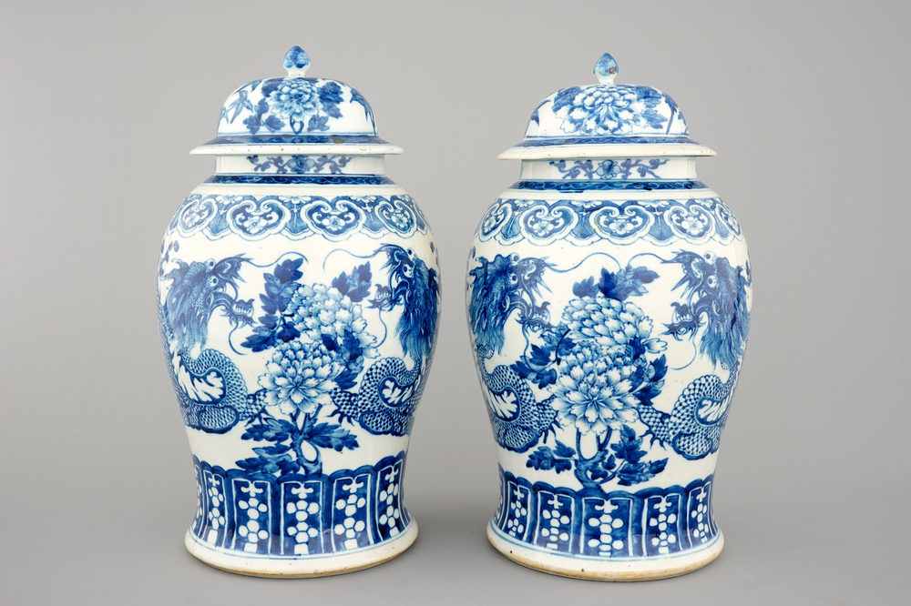 A pair of blue and white Chinese porcelain dragon vases and covers, 19th C.
