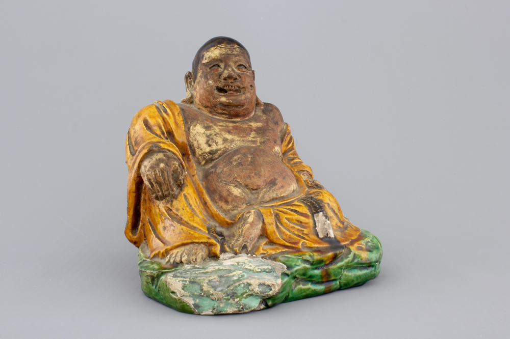 A Chinese sancai-glazed pottery Buddha, late Ming Dynasty
