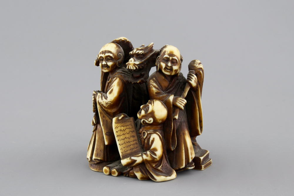 A Japanese patinated ivory netsuke: a dragon amongst sages, 19th C.