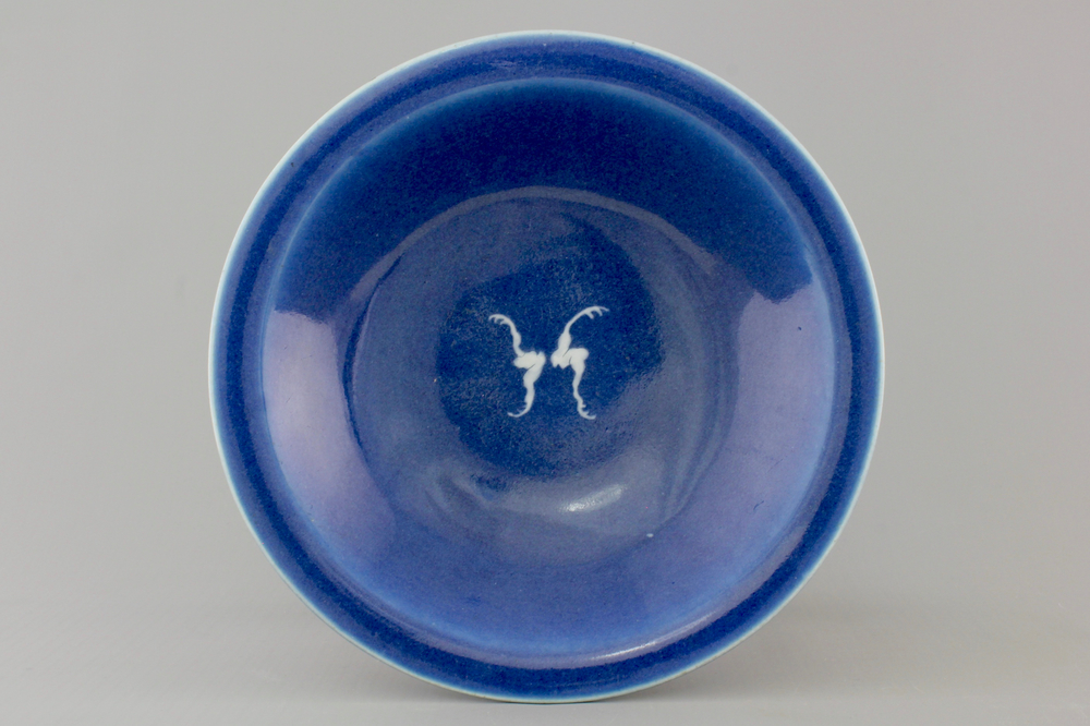 A Chinese porcelain monochrome blue ground plate with two bats, 19th C.