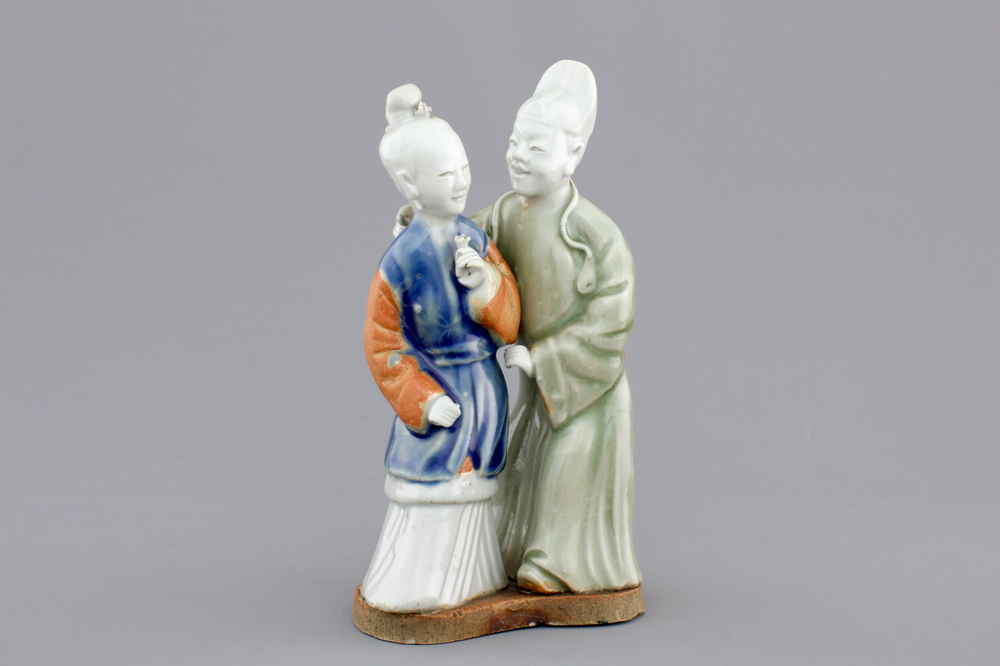 A Chinese celadon and blue-white biscuit group of a couple, Qianlong, 18th C.