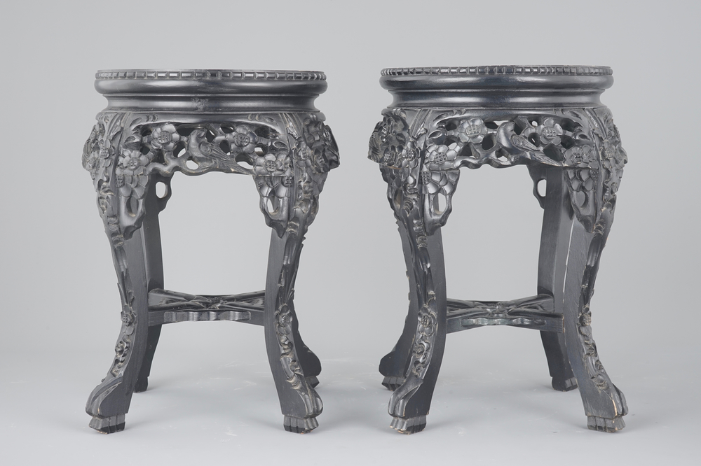 A pair of Chinese carved darkened wood vase stands with marble top, 20th C.