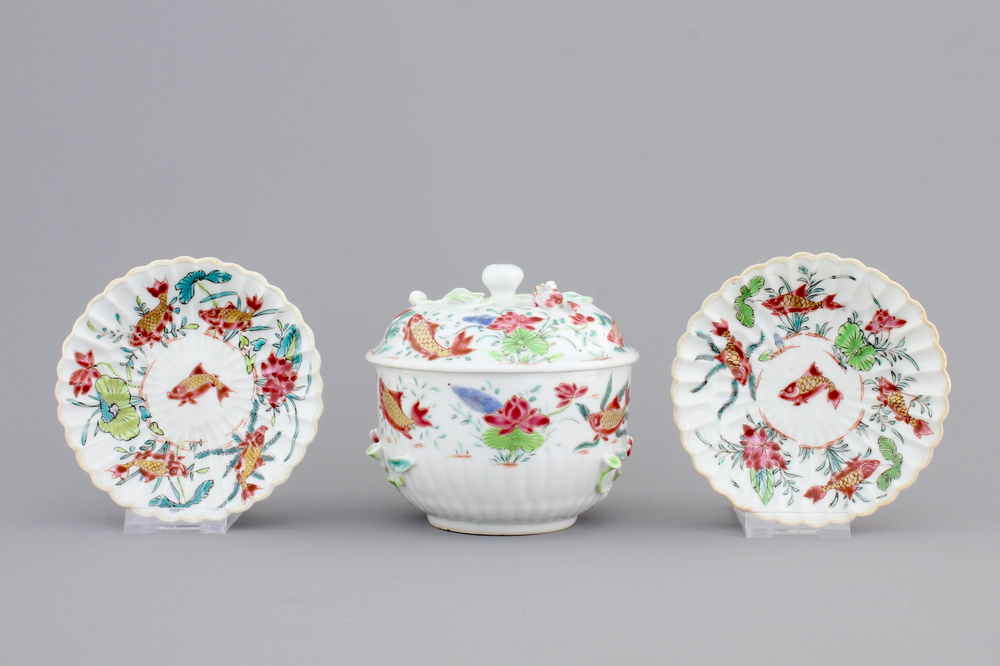 A Chinese famille rose and relief box and cover and two saucers with fish, Yongzheng, 1722-1735