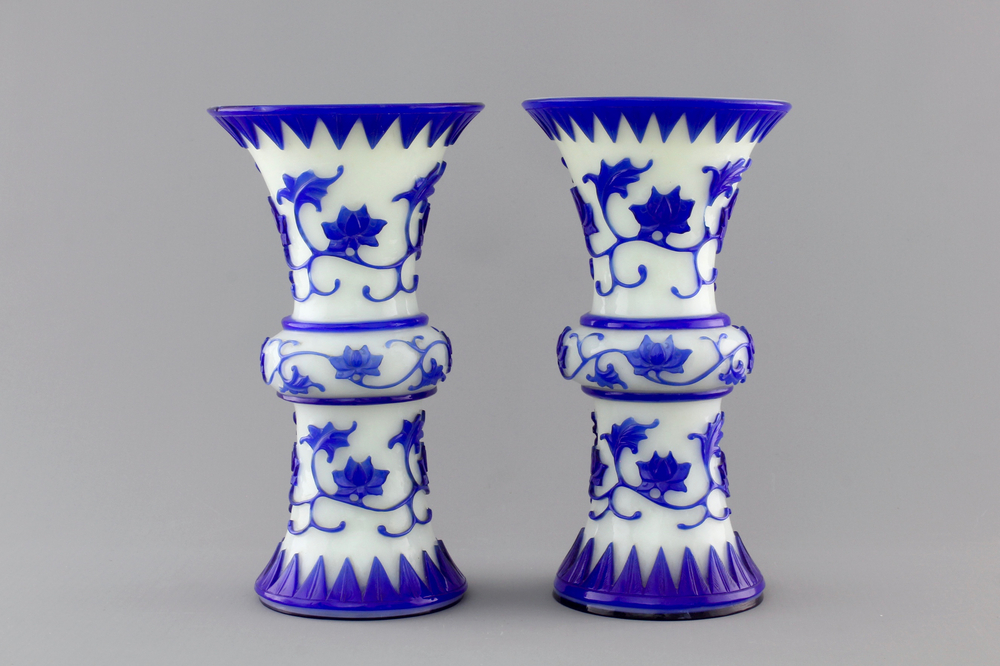 A pair of blue and white Chinese Peking overlay glass yenyen vases, early 20th C.