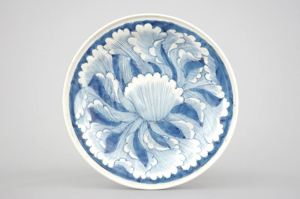 A Japanese Arita porcelain plate with relief-moulded decoration, 18th C.
