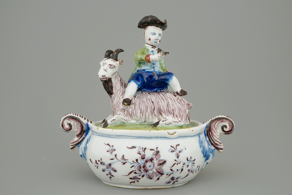 A Dutch Delft polychrome butter tub with a buckrider, 18th C.