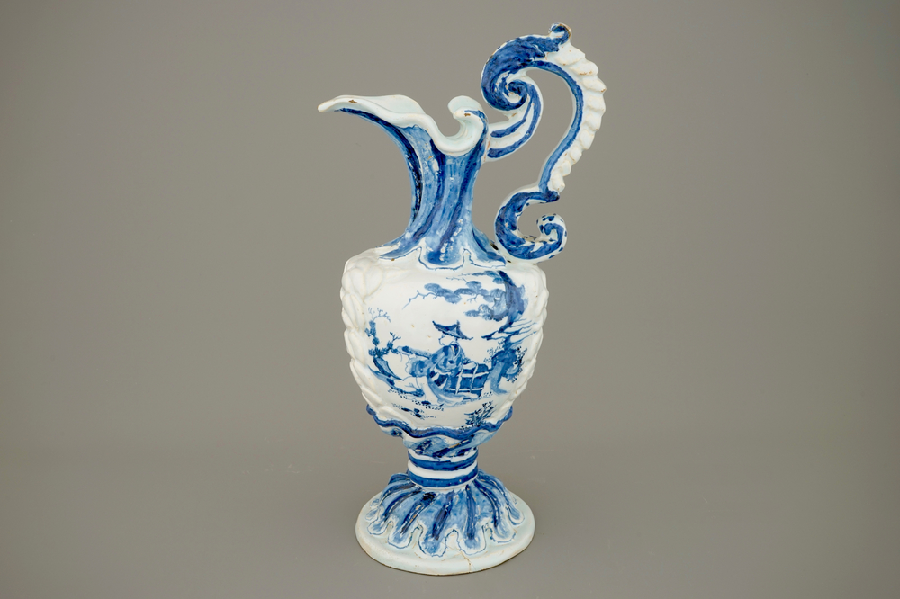 A large French faience blue and white relief-decorated jug, 18th C.