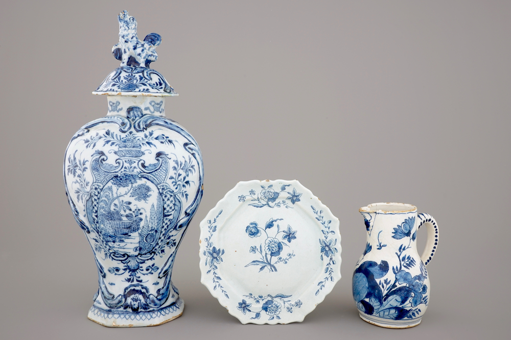 A large Dutch Delft blue and white vase and cover, a plate and a cream jug, 18th C.