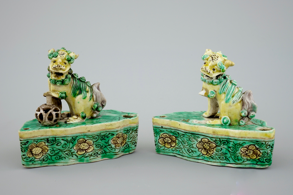 A pair of Chinese verte on biscuit foo dog joss stick holders, Kangxi