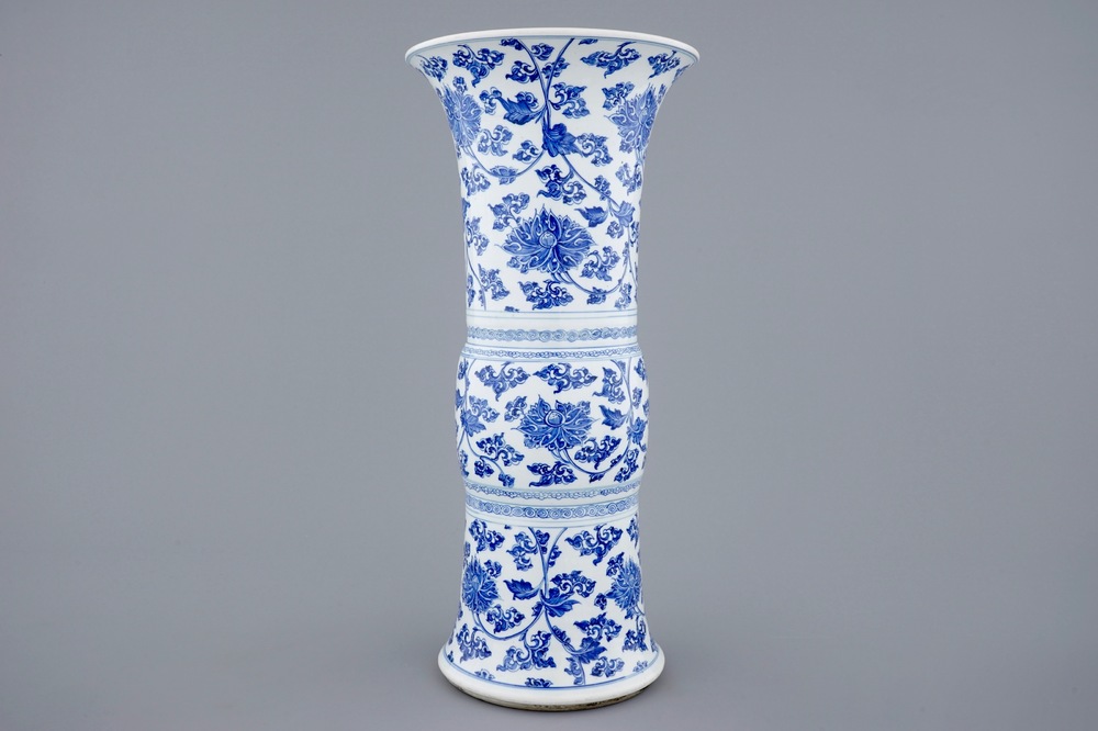 A Chinese blue and white lotus scroll gu beaker vase, Kangxi