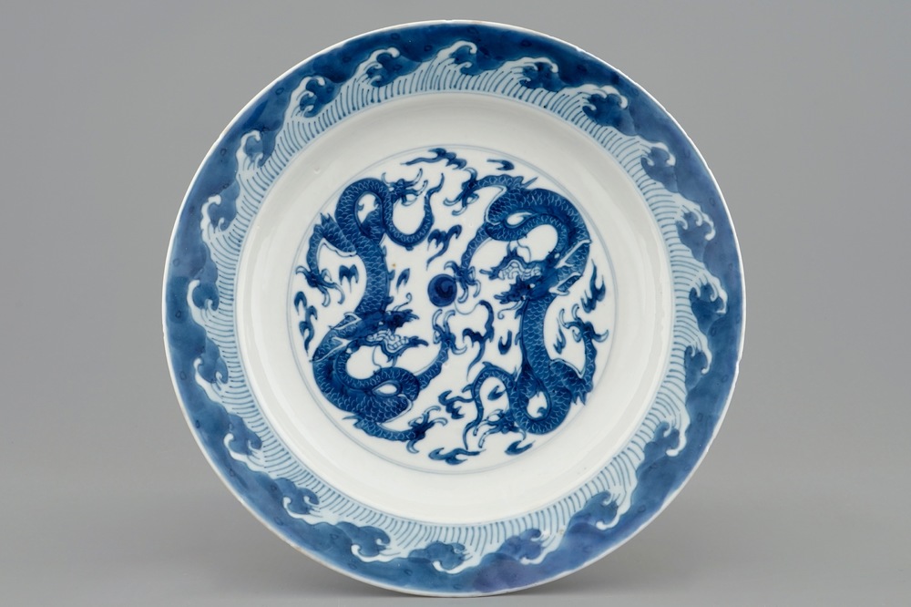 A Chinese blue and white plate with dragons chasing the pearl, Kangxi