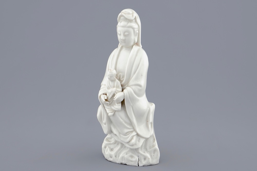 A Chinese Dehua blanc de Chine model of Guanyin with child, 19th C.