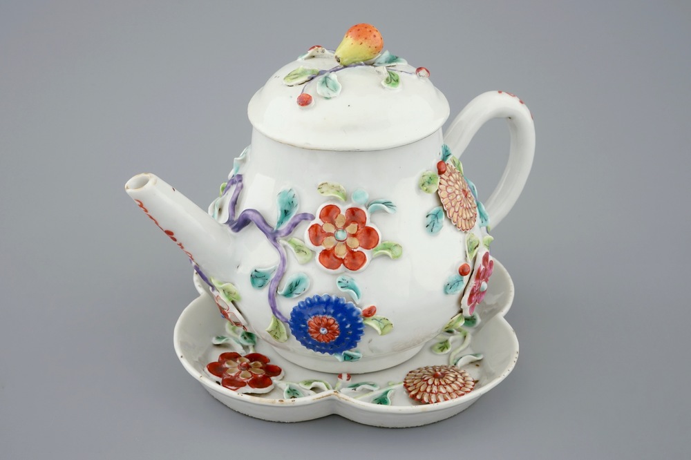 A Chinese moulded and applied famille rose teapot and cover on stand, Yongzheng, 1723-1735