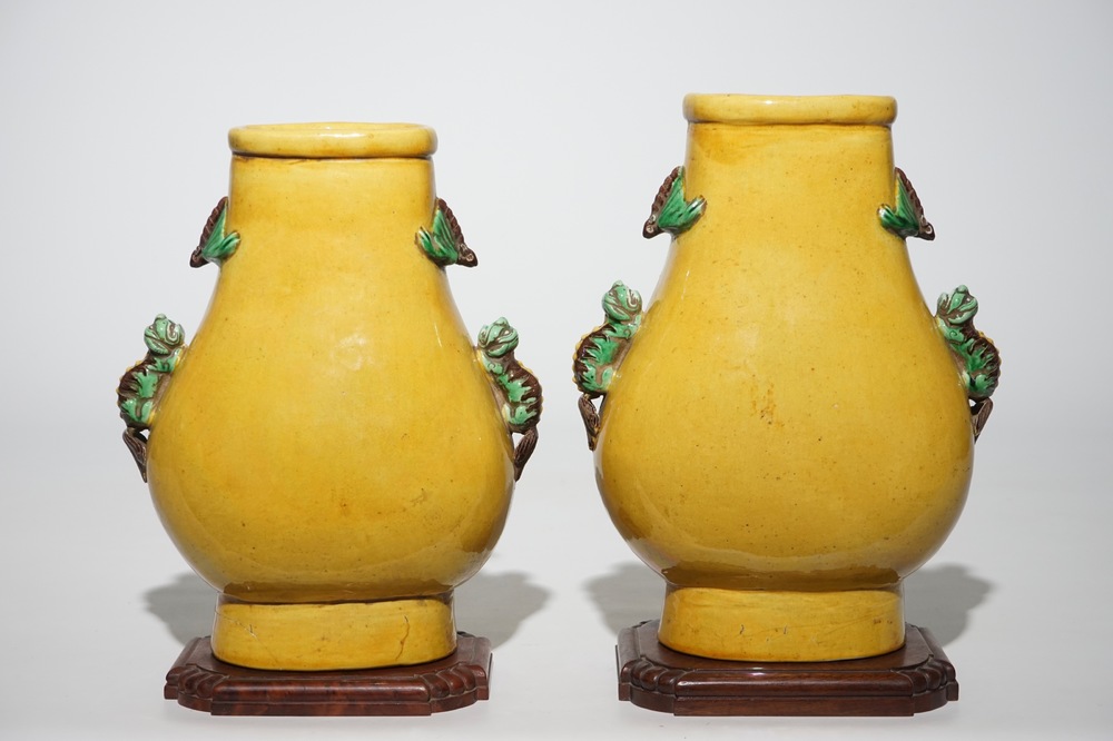 A pair of Chinese yellow glazed hu-shaped vases on stand, 19/20th C.