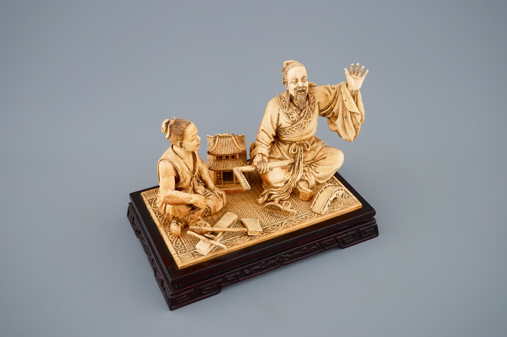 Un groupe en ivoire sculpt&eacute; d'un charpentier avec son &eacute;l&egrave;ve, vers 1900