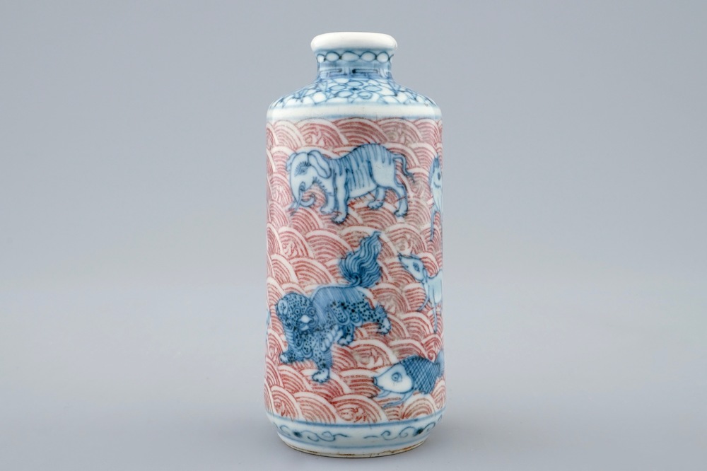 An unusual Chinese blue, white and underglaze red snuff bottle with animals, 18/19th C.