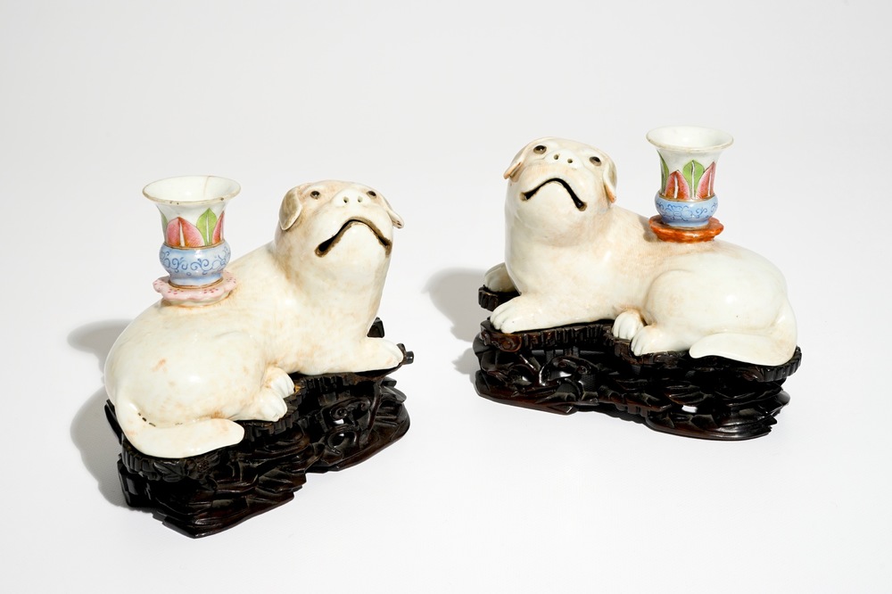 A pair of Chinese famille rose dog-shaped candle holders, 18/19th C.