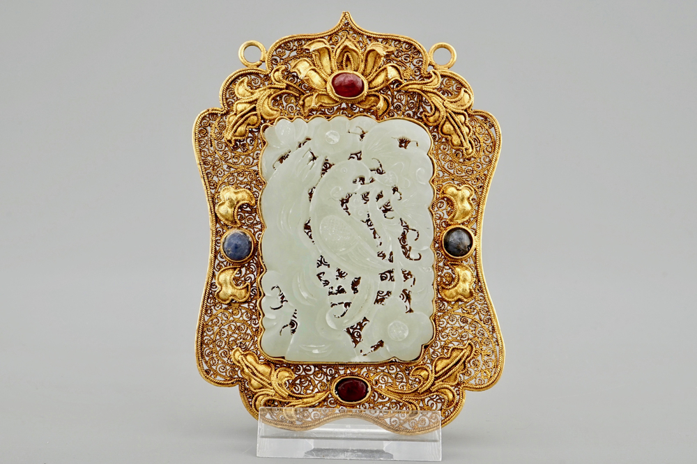 A Chinese gilt filigree silver hat ornament with jade inset, 19/20th C.