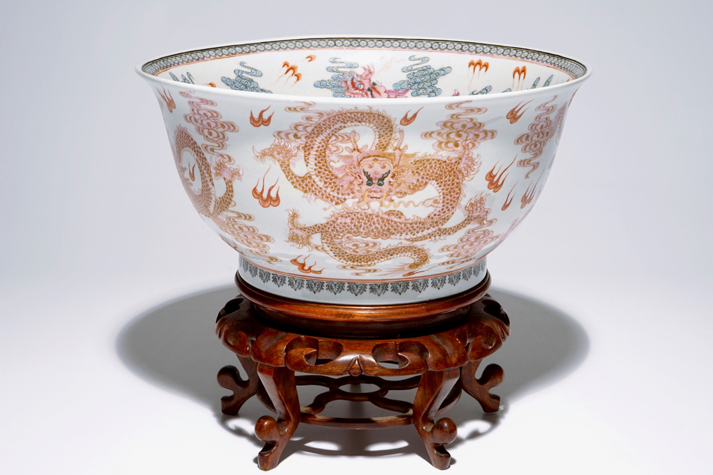 A large Chinese famille rose "dragon" bowl on a wooden stand, 20th C.