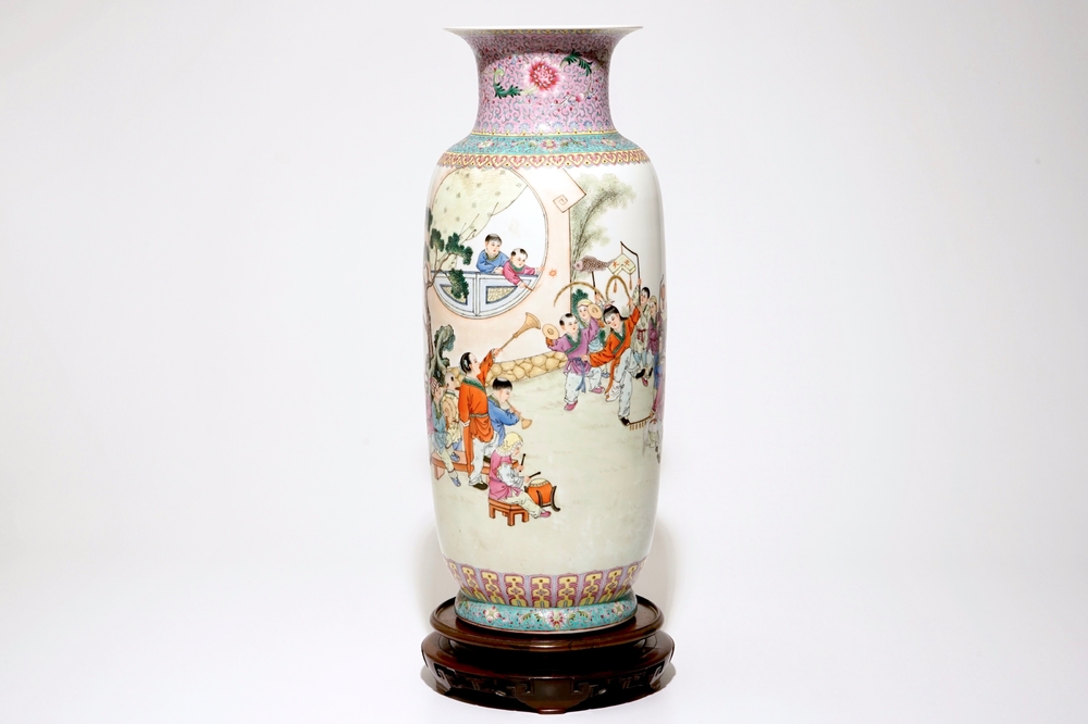 A large Chinese famille rose vase with playing boys, on a wooden stand, 20th C.