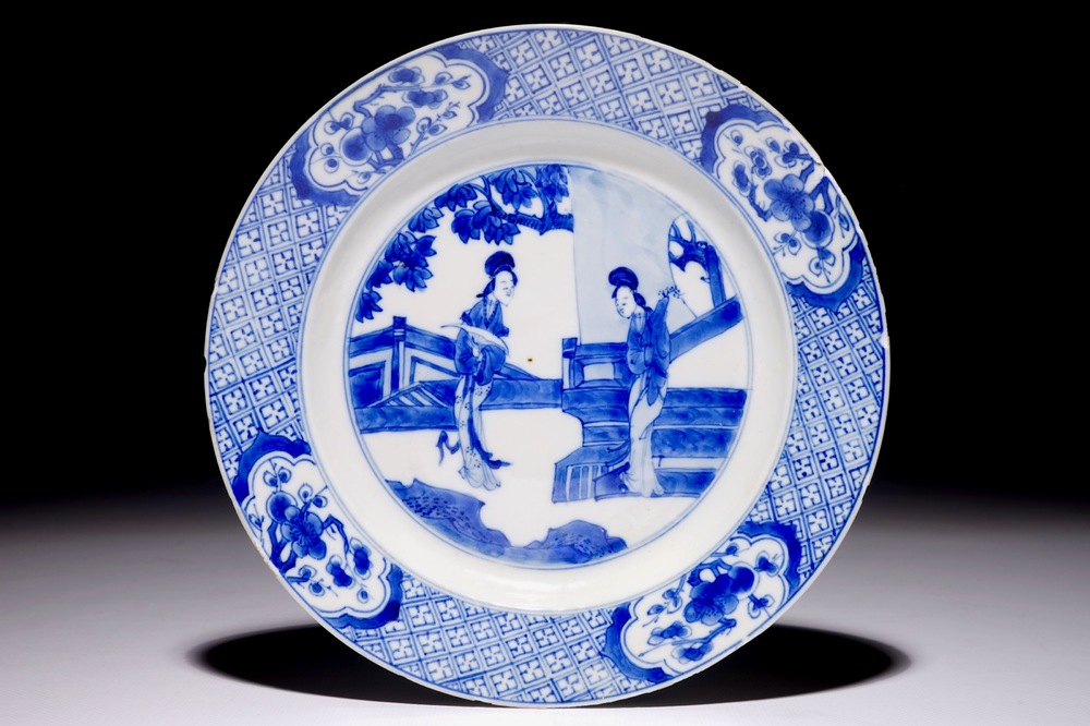 A Chinese blue and white plate with "Long Elizas" in the garden, Kangxi