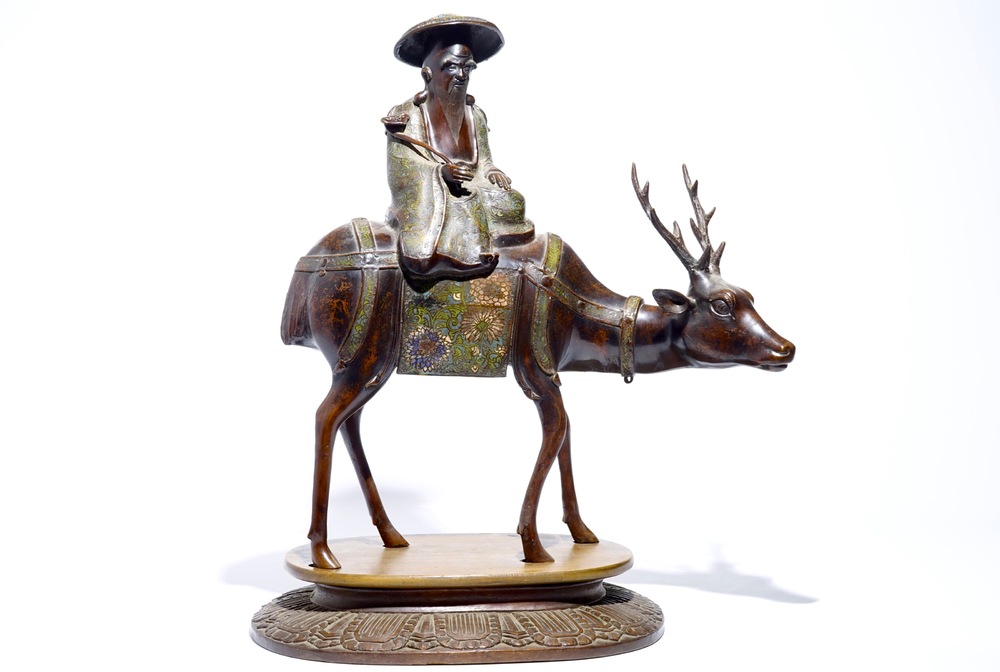 A large Chinese bronze and cloisonn&eacute; model of Shou Lao on a deer, on wooden base, 19/20th C.