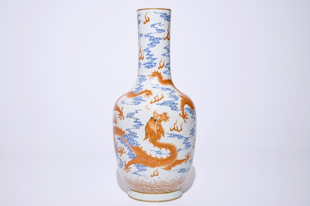 A Chinese iron red and overglaze blue vase with dragons among clouds, 19/20th C.