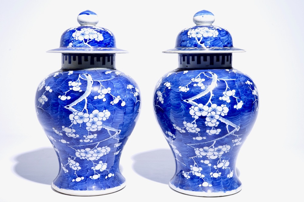 A pair of Chinese blue and white covered jars with "prunus on breaking ice" design, 19th C