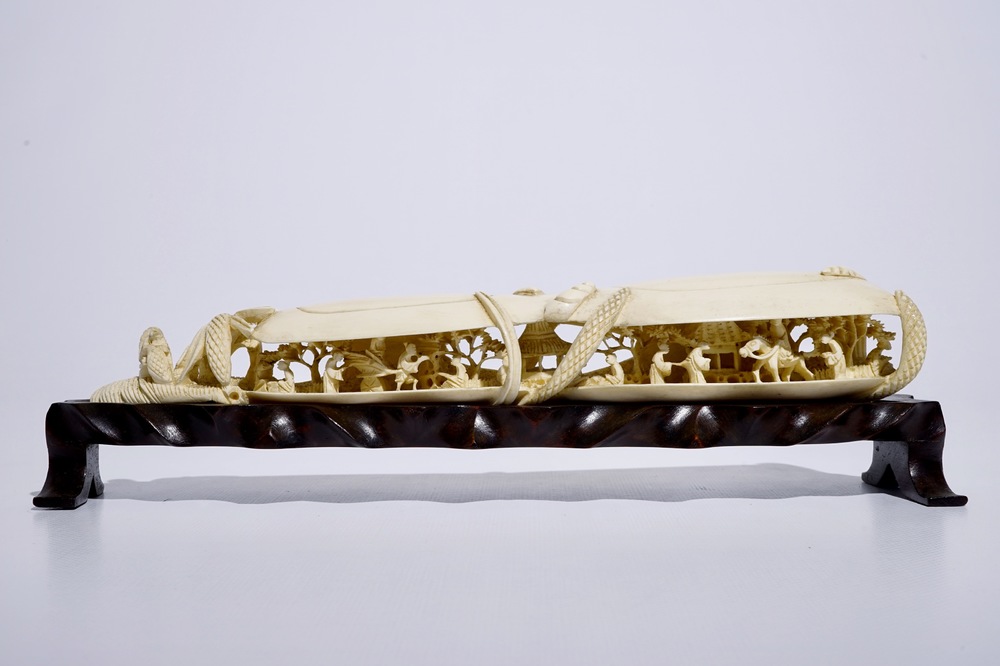 A Chinese shell-shaped ivory group on wooden stand, early 20th C.