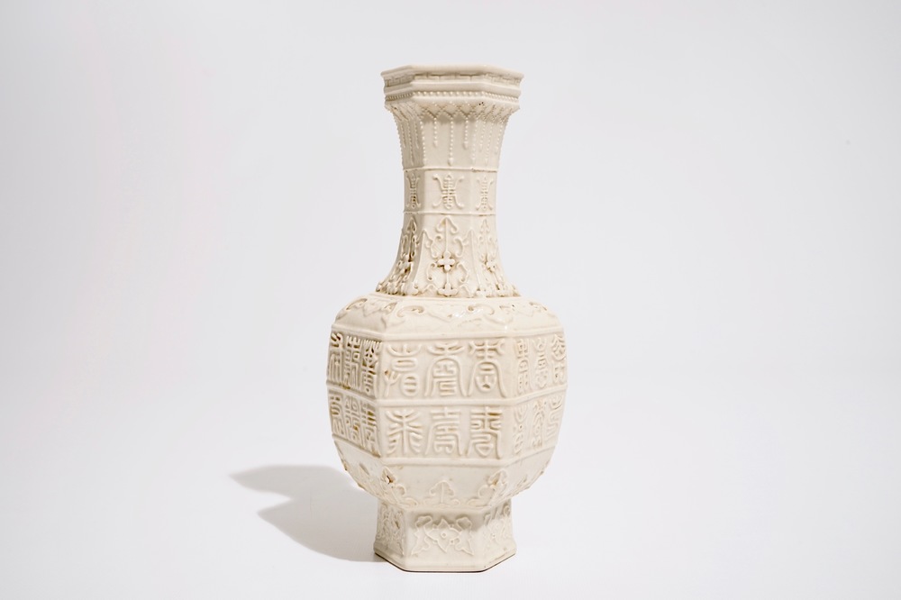 A Chinese white-glazed relief-decorated vase with text bands, 19th C.