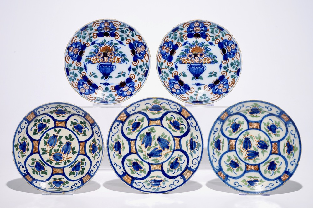 A pair and a set of three Dutch Delft polychrome plates, 18th C.