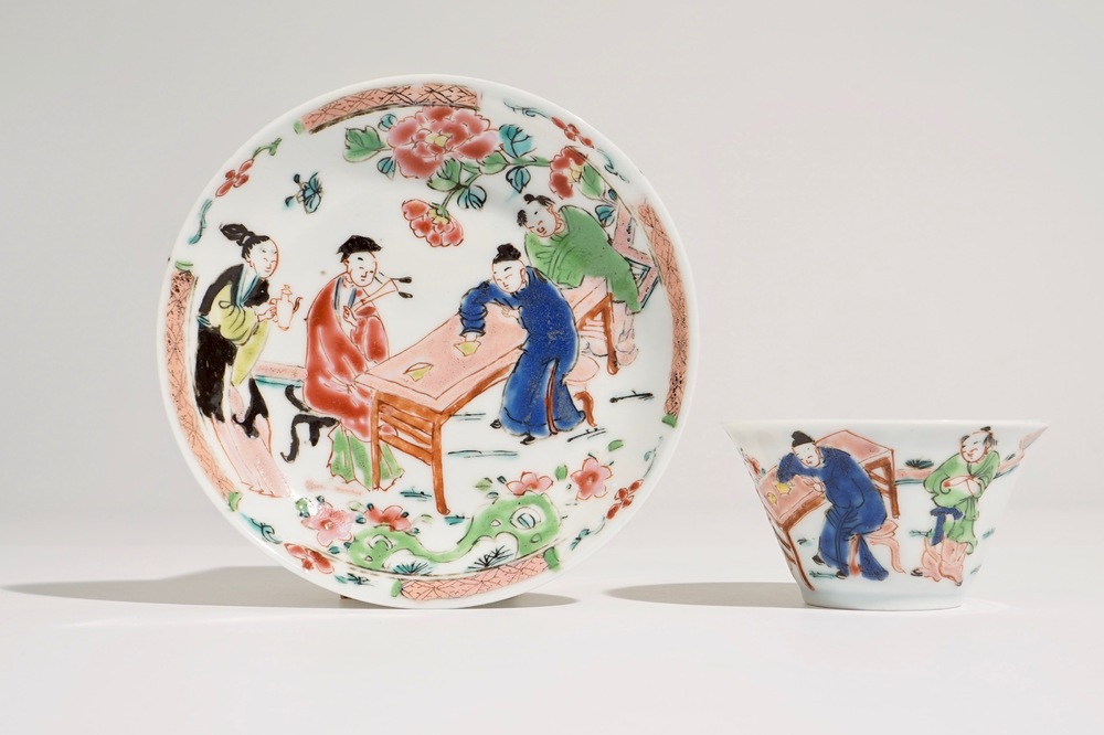 A Chinese famille rose cup and saucer with a tea-drinking scene, Yongzheng