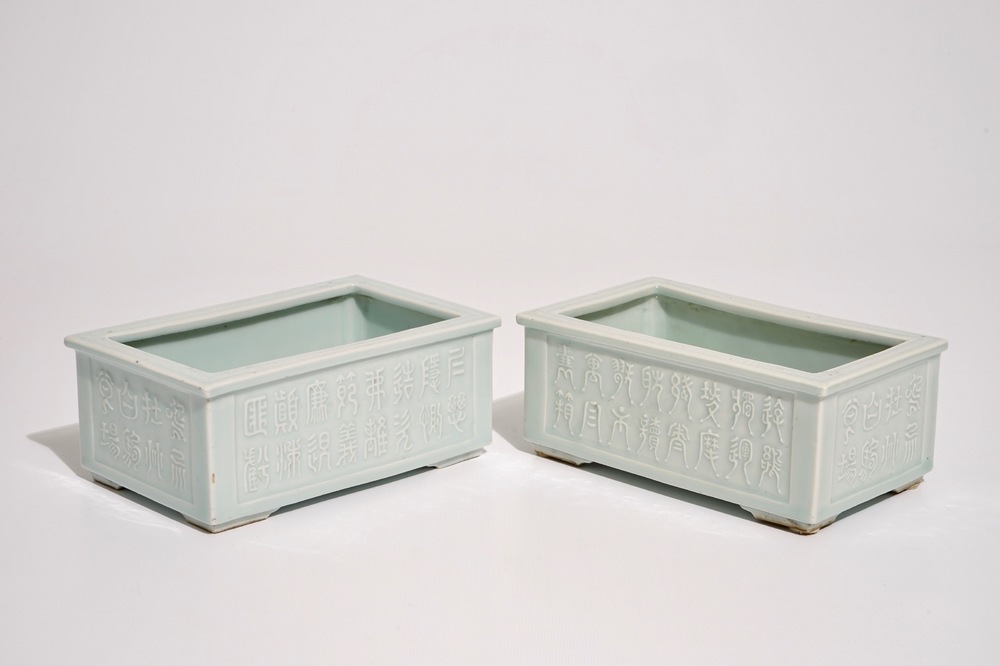 A pair of Chinese relief-decorated celadon-glazed rectangular jardinieres, Yongzheng mark, 19th C.