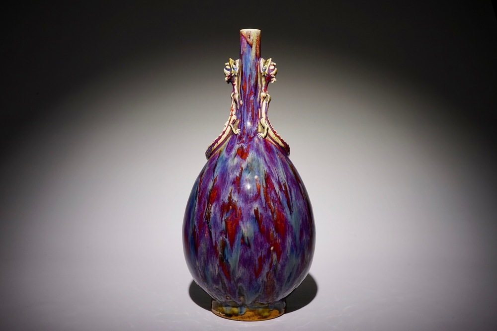 A Chinese monochrome flambe-glazed bottle vase with dragon handles, 19th C.