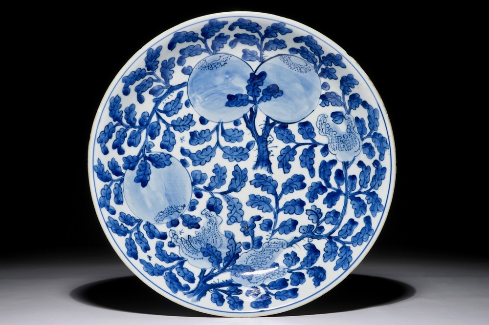 A Chinese blue and white dish with sanduo fruits among foliage, Kangxi