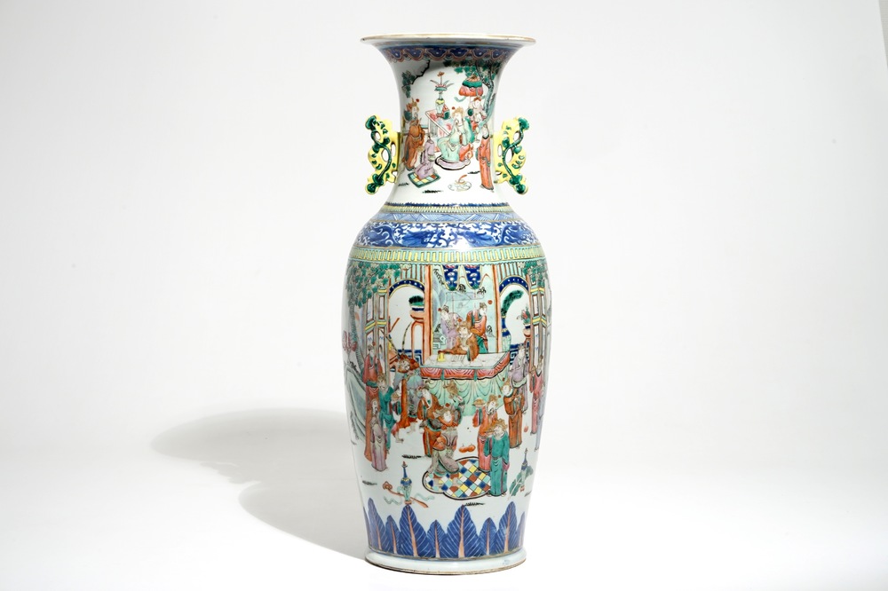 A tall Chinese famille rose vase with a court scene and peacocks, 19th C.