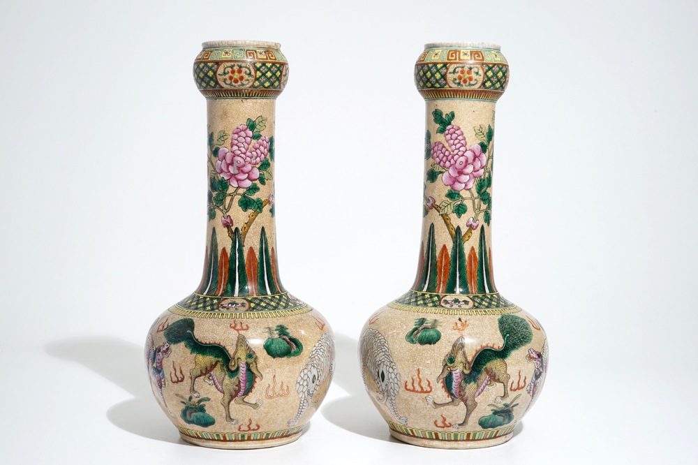 A pair of Chinese crackle-glazed bottle vases with kylins and elephants, 19th C.