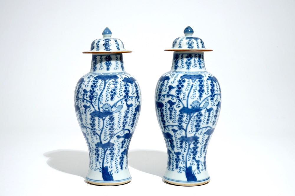 A pair of Chinese blue and white vases and covers with grapes, Kangxi