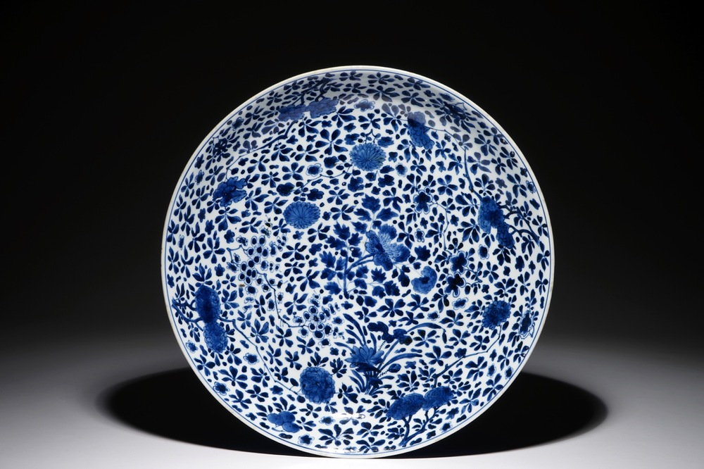 A large Chinese blue and white charger with floral design and powder blue back, Chengua mark, Kangxi
