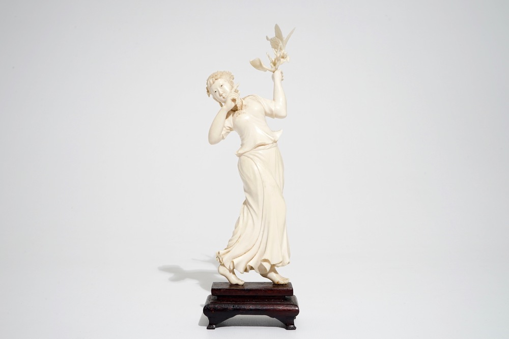 A Chinese ivory figure of a lady with a butterfly, early 20th C.