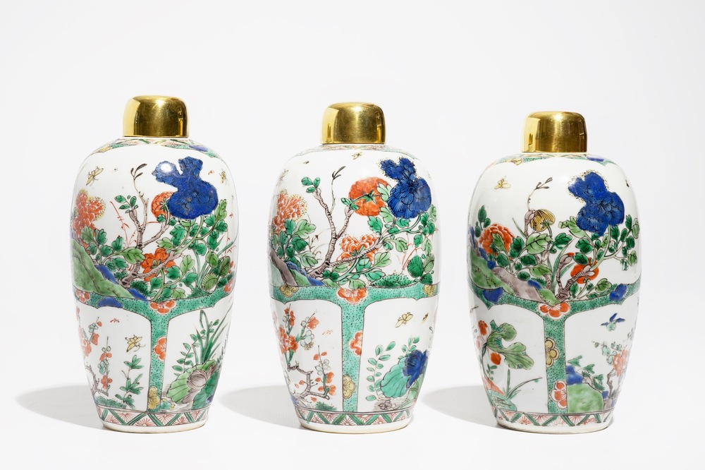 Three Chinese famille verte jars with floral design and gilt metal covers, Kangxi