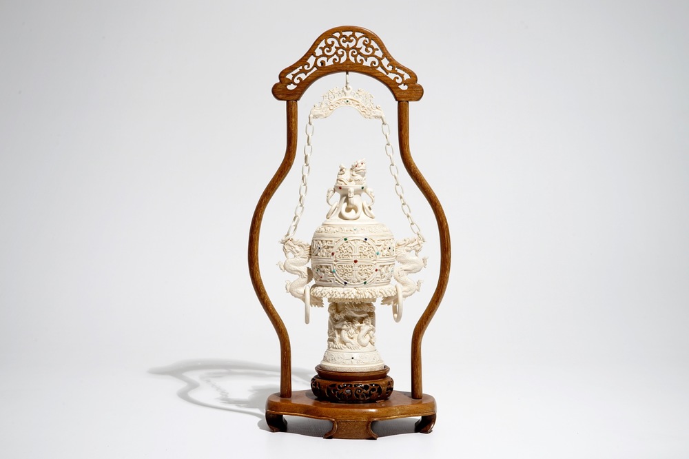 A Chinese encrusted ivory vase on wooden stand, early 20th C.