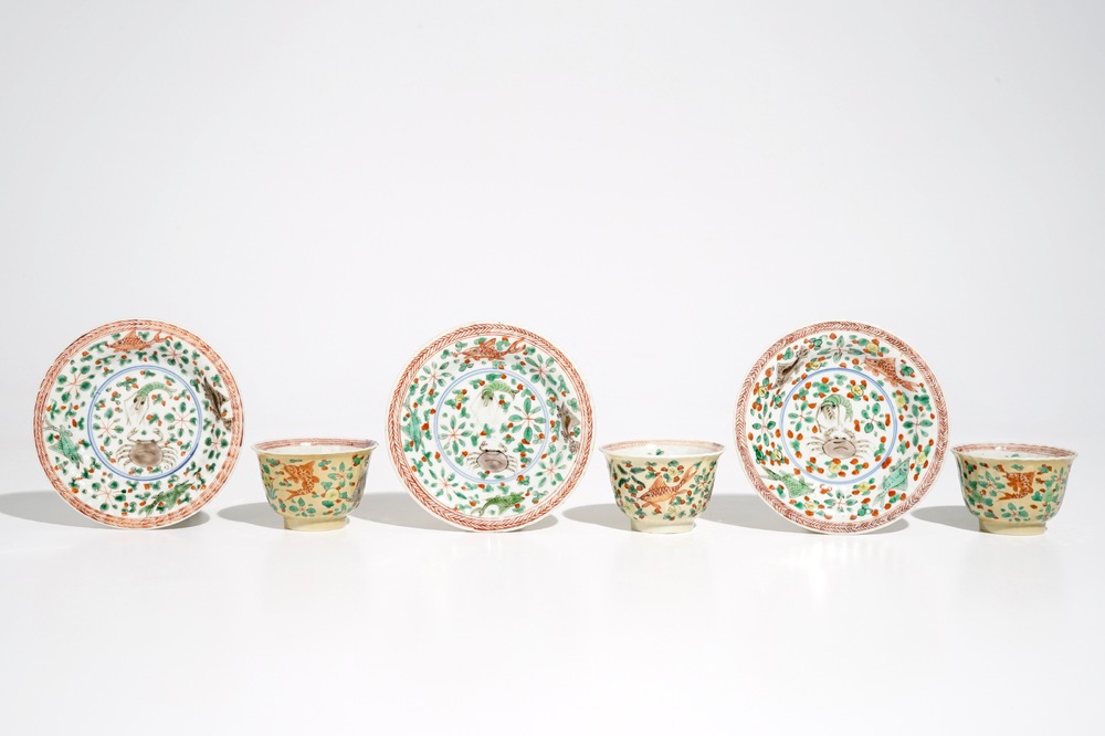 Three Chinese famille verte caf&eacute; au lait-ground cups and saucers with crabs and fish, Kangxi