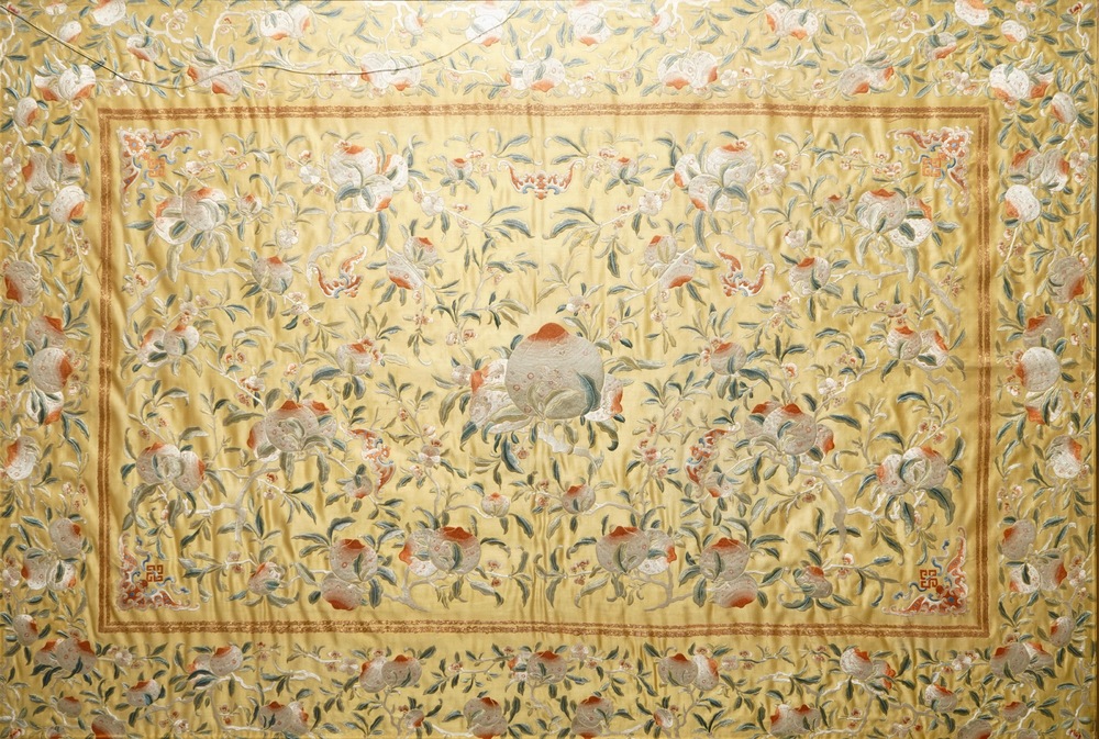 A Chinese embroidered yellow-ground silk cloth with peaches, Qing