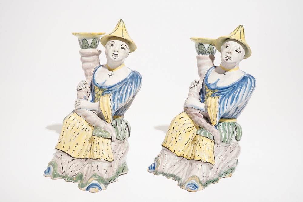 A pair of polychrome Brussels faience candlesticks modelled as chinamen, ca. 1800